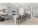 Modern kitchen featuring gray cabinets, a large center island with seating, and stainless steel appliances at 2877 Fitness St, Clermont, FL 34714