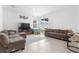 Spacious living room with tile flooring, a comfortable seating area, and access to the backyard at 2877 Fitness St, Clermont, FL 34714