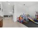 A play room with tile flooring, next to a dining area and living space, perfect for Gathering time at 2877 Fitness St, Clermont, FL 34714