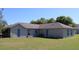 Large backyard with potential for outdoor living, the home features a neutral exterior paint scheme at 3171 Santa Cruz Dr, Kissimmee, FL 34746