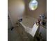 Bathroom features a tub, window, tile flooring, and is brightly lit at 3171 Santa Cruz Dr, Kissimmee, FL 34746