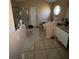 Bathroom features a combination tub and shower, window, tile flooring, toilet, and sink with vanity at 3171 Santa Cruz Dr, Kissimmee, FL 34746