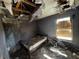 Bedroom with extensive fire damage, revealing the bed and window at 3171 Santa Cruz Dr, Kissimmee, FL 34746