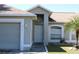 Inviting front door with well-manicured lawn and garden, featuring a charming single-story home at 3171 Santa Cruz Dr, Kissimmee, FL 34746