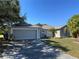 Charming single-story home featuring a two-car garage, well-maintained lawn, and a freshly painted facade at 3171 Santa Cruz Dr, Kissimmee, FL 34746