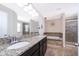 Bathroom showcasing double vanity, granite counters, soaking tub, and glass-enclosed shower at 3252 Toscana Dr, St Cloud, FL 34772