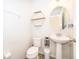 Neutral powder room with pedestal sink, sleek fixtures, and tiled floors at 3252 Toscana Dr, St Cloud, FL 34772