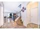 Spacious entryway with tile floors, staircase, and an archway into a brightly-lit living area at 3252 Toscana Dr, St Cloud, FL 34772