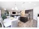 Open-concept kitchen and dining area with dark cabinets, granite countertops, and stainless appliances at 3252 Toscana Dr, St Cloud, FL 34772