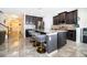 Stylish kitchen island featuring modern stools, granite countertops, and stainless steel appliances at 3252 Toscana Dr, St Cloud, FL 34772