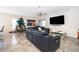 Open-concept living room with tile floors, a large TV, and a comfortable sectional sofa at 3252 Toscana Dr, St Cloud, FL 34772