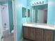 Updated bathroom with blue walls, shower-tub, and wooden vanity at 3561 Sanctuary Dr, St Cloud, FL 34769