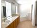 Bright bathroom featuring a soaking tub, double vanity and tiled floors at 3561 Sanctuary Dr, St Cloud, FL 34769