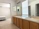 Bright bathroom featuring a double vanity and abundant natural light, adjacent to a bedroom at 3561 Sanctuary Dr, St Cloud, FL 34769