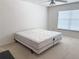 Bright, minimalist bedroom featuring a bed, neutral walls, a ceiling fan, and a window with natural light at 3561 Sanctuary Dr, St Cloud, FL 34769