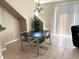 Dining area with contemporary table and chairs, positioned near a staircase and a sliding glass door at 3561 Sanctuary Dr, St Cloud, FL 34769