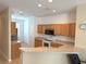 Bright kitchen featuring stainless steel appliances, wood cabinets, ample counter space, and tile flooring at 3561 Sanctuary Dr, St Cloud, FL 34769