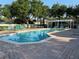 Community pool surrounded by lush landscaping and lounge chairs, creating a relaxing atmosphere at 3561 Sanctuary Dr, St Cloud, FL 34769