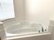 Bright bathroom featuring a corner soaking tub and tiled surround at 3561 Sanctuary Dr, St Cloud, FL 34769