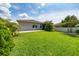 Lush backyard with tropical landscaping and well-maintained lawn at 4007 Green Sabal Dr, Orlando, FL 32824