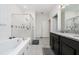 Bathroom features a tub with glass door and shower, and a vanity with granite countertop at 4007 Green Sabal Dr, Orlando, FL 32824