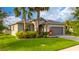Charming single-story home with a well-manicured lawn, lush landscaping, and a two-car garage at 4007 Green Sabal Dr, Orlando, FL 32824