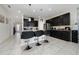 Modern kitchen featuring dark cabinets, granite countertops, a center island with seating, and stainless steel appliances at 4007 Green Sabal Dr, Orlando, FL 32824
