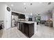 Open-concept kitchen with dark cabinetry, granite counters, stainless steel appliances, and a view into the living area at 4007 Green Sabal Dr, Orlando, FL 32824