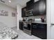 Well-equipped kitchen with dark cabinetry, granite countertops, and stainless steel appliances for modern convenience at 4007 Green Sabal Dr, Orlando, FL 32824