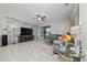 Living room with a stone accent wall, a large tv, and a sliding door to the outside at 4007 Green Sabal Dr, Orlando, FL 32824