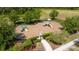 Aerial view of fenced community playground with slides and benches, surrounded by lush landscaping and trees at 4007 Green Sabal Dr, Orlando, FL 32824