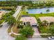 Aerial view of home with lush landscaping and a view of the neighborhood pond at 4125 Navigator Way, Kissimmee, FL 34746