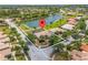 Aerial view of home with view of the pond, trees, and surrounding neighborhood at 4125 Navigator Way, Kissimmee, FL 34746