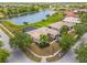 Aerial view of home with view of the pond, trees, and surrounding neighborhood at 4125 Navigator Way, Kissimmee, FL 34746