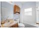 Bathroom featuring a sink with wood cabinets, a toilet, and a shower/tub combo with a curtain at 4125 Navigator Way, Kissimmee, FL 34746