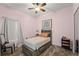 Bedroom featuring wood-look floors, a bed, and a window with sheer curtains at 4125 Navigator Way, Kissimmee, FL 34746