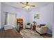 Bedroom with chair seating, book shelves, desk, wood-look floors, and bright, neutral paint at 4125 Navigator Way, Kissimmee, FL 34746