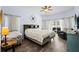 Bright and airy bedroom featuring tile floors, ceiling fan, and private patio access at 4125 Navigator Way, Kissimmee, FL 34746