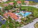 Aerial view of a large community pool with ample lounge seating and a nearby clubhouse at 4125 Navigator Way, Kissimmee, FL 34746