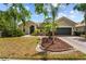 Charming single-story home featuring lush landscaping, a brick driveway, and a two-car garage at 4125 Navigator Way, Kissimmee, FL 34746
