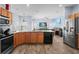 Open kitchen features granite countertops, stainless steel appliances, and oak cabinets at 4125 Navigator Way, Kissimmee, FL 34746