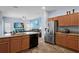 Well-lit kitchen with stainless appliances, oak cabinets, and open view to living room at 4125 Navigator Way, Kissimmee, FL 34746