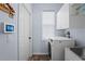 Laundry room with a white washer and dryer, white cabinets, and a sink at 4125 Navigator Way, Kissimmee, FL 34746