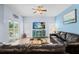 Living room with sliding glass doors, a ceiling fan, and comfortable seating at 4125 Navigator Way, Kissimmee, FL 34746