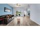 Spacious living room with light blue accent wall and modern wood-look flooring at 4125 Navigator Way, Kissimmee, FL 34746