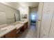 Bathroom featuring a long vanity, with a view to an adjacent bedroom at 4525 Sw 52Nd Cir # 103, Ocala, FL 34474