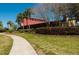 Exterior of clubhouse with walkway, colorful landscaping, and lush foliage at 4525 Sw 52Nd Cir # 103, Ocala, FL 34474