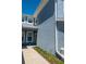 Side view of a light blue townhouse with well-maintained landscaping and visible window details at 4525 Sw 52Nd Cir # 103, Ocala, FL 34474