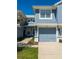 A charming two-story home features a light blue exterior, attached garage, and well-maintained landscaping at 4525 Sw 52Nd Cir # 103, Ocala, FL 34474