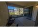 Cozy screened-in patio featuring comfortable seating and a peaceful view of the well-maintained community grounds at 4525 Sw 52Nd Cir # 103, Ocala, FL 34474